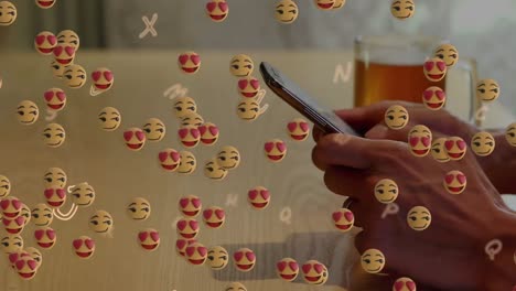 Animation-Schwebender-Emojis-über-Der-Hand-Mit-Dem-Smartphone