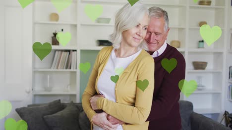 Animation-of-hearts-over-senior-caucasian-couple-embracing