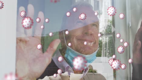 Animation-of-virus-cells-over-happy-senior-caucasian-man-with-face-mask
