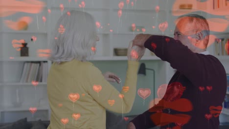 Animation-of-heart-icons-over-senior-caucasian-couple-dancing