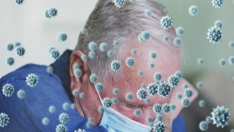 Animation-of-covid-19-cells-over-man-wearing-face-mask