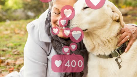 Animation-of-social-media-icons-with-growing-number-over-senior-caucasian-woman-with-her-pet-dog