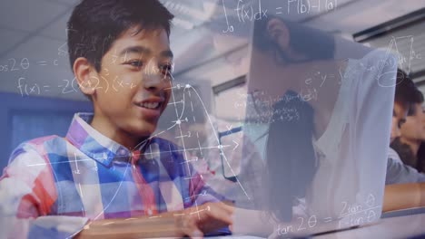 Animation-of-mathematical-equations-over-schoolboy-using-laptop-in-classroom