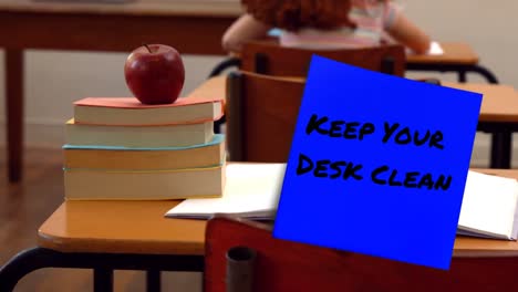 Animation-of-keep-your-desk-clean-text-over-schoolgirl-in-classroom
