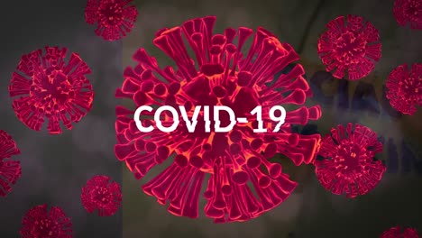 Animation-of-covid-19-text-over-multiple-red-virus-cells
