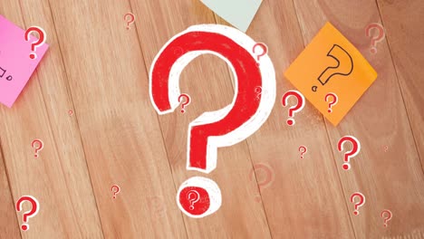 Animation-of-red-question-marks-over-multicolour-memo-notes-on-wooden-background