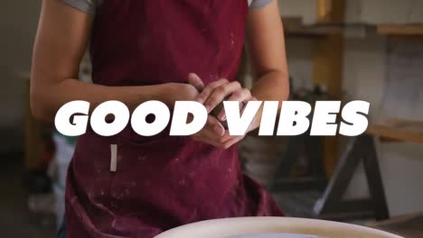 Animation-of-good-vibes-text-over-hands-of-biracial-woman-forming-pottery