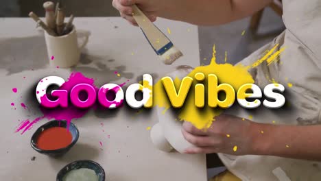 Animation-of-good-vibes-text-over-hands-of-caucasian-man-painting-pottery