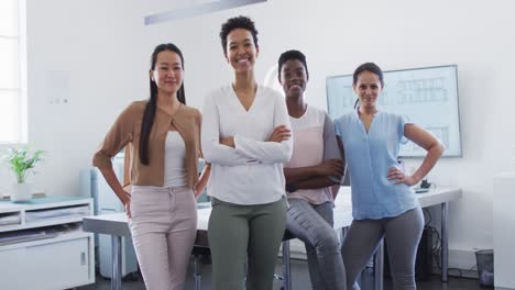 Group-of-happy-diverse-businesswomen-standing-in-office-and-looking-at-camera