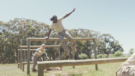 Diverse-group-of-soldiers-going-over-and-under-hurdles-on-army-style-obstacle-course-in-the-sun