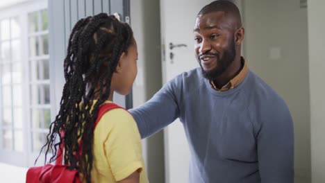 Happy-african-american-father-talking-with-daughter-before-leaving-to-school