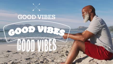 Animation-of-good-vibes-text-over-senior-african-american-man-sitting-at-beach
