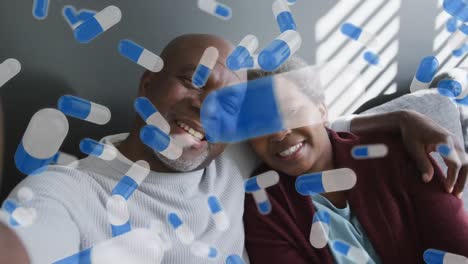 Animation-of-pill-icons-over-senior-african-american-couple