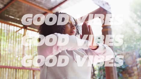 Animation-of-good-vibes-text-over-african-american-woman-practicing-yoga