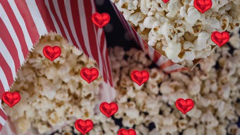 Animation-of-heart-icons-over-boxes-of-popcorn