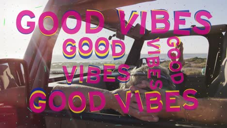 Animation-of-good-vibes-text-over-caucasian-man-lying-in-car