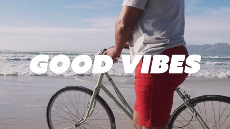 Animation-of-good-vibes-text-over-senior-african-american-man-walking-with-bike-at-beach