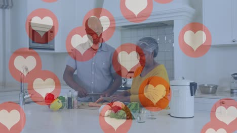 Animation-of-heart-icons-over-senior-african-american-couple-in-kitchen
