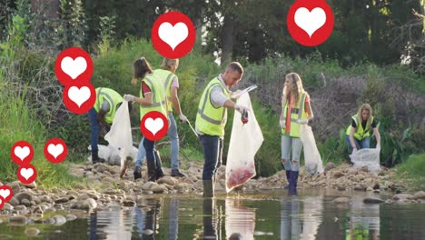 Animation-of-red-hearts-over-diverse-group-picking-up-rubbish-by-river-in-countryside