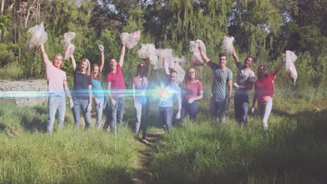 Video-of-lights-over-cheering-diverse-volunteer-group-picking-up-rubbish-in-countryside