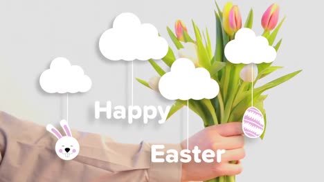 Animation-of-happy-easter-text-over-hand-holding-flowers