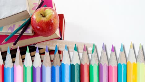 Animation-of-pencils-over-school-items-on-white-background