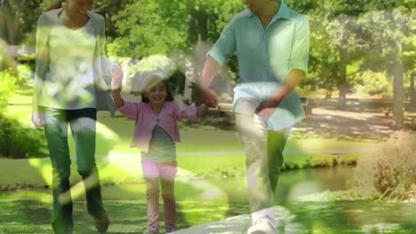 Video-Von-Lichtern-über-Gemischtrassigen-Eltern-Mit-Ihrer-Tochter,-Die-In-Der-Natur-Spazieren-Gehen