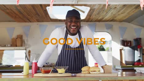 Animation-of-good-vibes-text-with-african-american-man-smiling