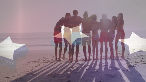 Animation-of-american-flag-over-diverse-group-of-friends-embracing-at-beach