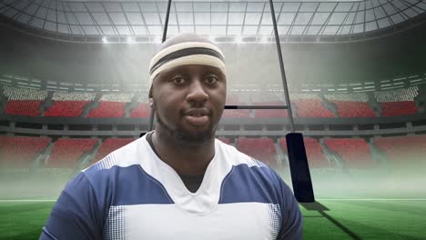 Animation-of-african-american-male-rugby-player-holding-ball-over-stadium