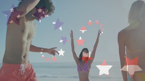 Animation-of-american-flag-over-diverse-group-of-friends-dancing-at-beach