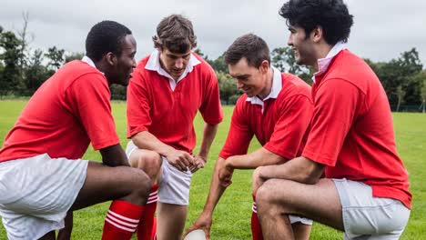 Animation-of-diverse-male-rugby-players-holding-ball-at-stadium