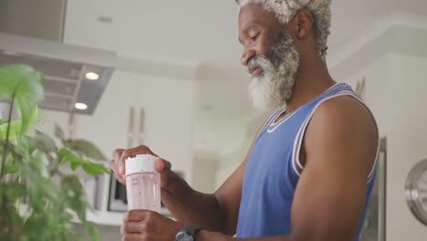 Video-of-african-american-senior-man-preparing-smoothie