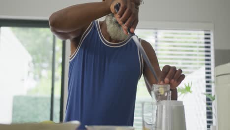 Video-of-african-american-senior-man-preparing-smoothie