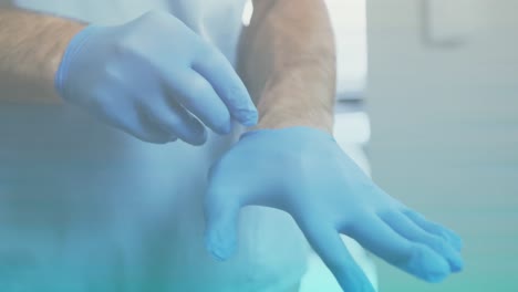 Animation-of-caucasian-male-doctor-wearing-rubber-gloves-in-hospital