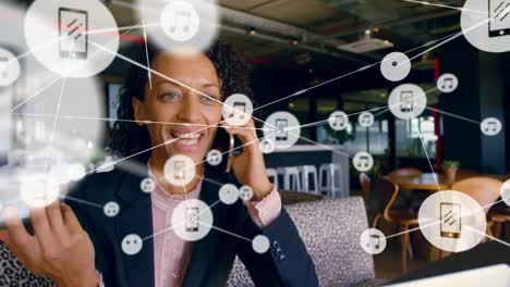 Animation-of-network-of-connections-with-icons-over-biracial-businesswoman-using-smartphone