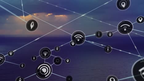Network-of-digital-icons-against-landscape-with-sea-and-sunset-sky