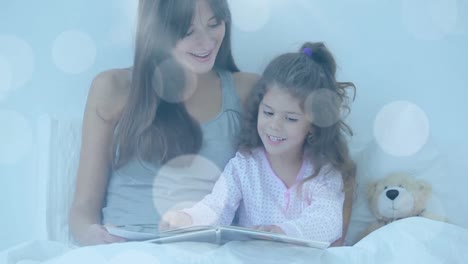 Animation-of-light-spots-over-caucasian-woman-and-her-daughter-reading-books
