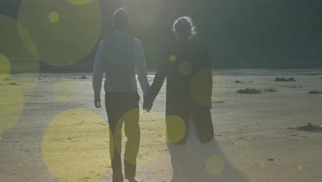 Animation-of-light-spots-over-caucasian-couple-walking-and-holding-hands