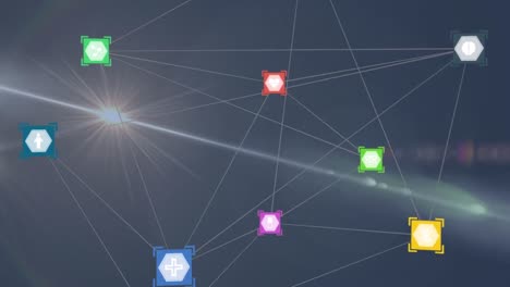 Network-of-digital-icons-against-spot-of-light-and-lens-flare-on-blue-background