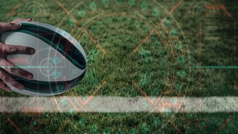 Digital-interface-with-data-processing-against-close-up-of-hand-holding-a-rugby-ball