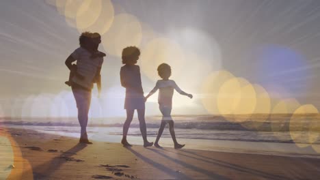Animation-of-light-spots-over-african-american-family-walking-together