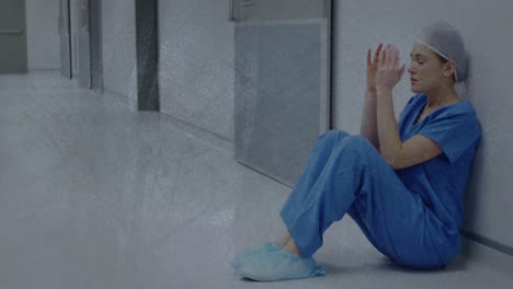 Animation-of-moving-shapes-over-sad-caucasian-female-nurse-sitting-in-hospital