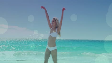 Animation-of-light-spots-over-caucasian-woman-walking-on-beach