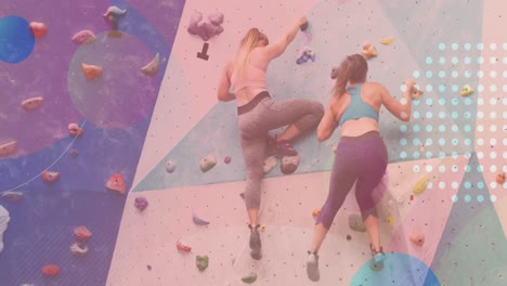 Animation-of-spots-over-two-caucasian-women-on-climbing-wall