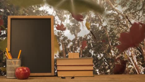 Animation-of-autumn-leaves-falling-over-books-and-blackboard