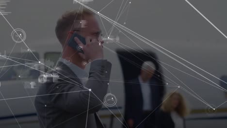 Animation-of-data-processing-over-caucasian-businessman-talking-on-smartphone