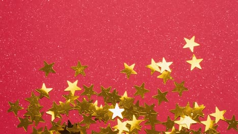 Animation-of-snow-falling-over-glowing-golden-stars-and-red-background