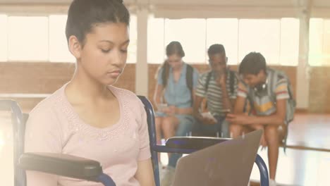 Animation-of-lights-over-happy-disabled-biracial-female-student-using-laptop-at-school
