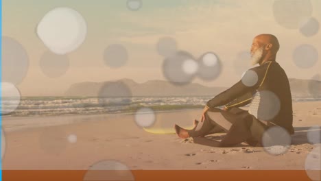 Animation-of-spots-over-senior-african-american-man-with-surfboard-at-beach